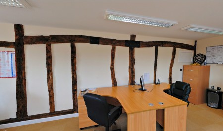 Upper office arranged as a meeting room or executive space.